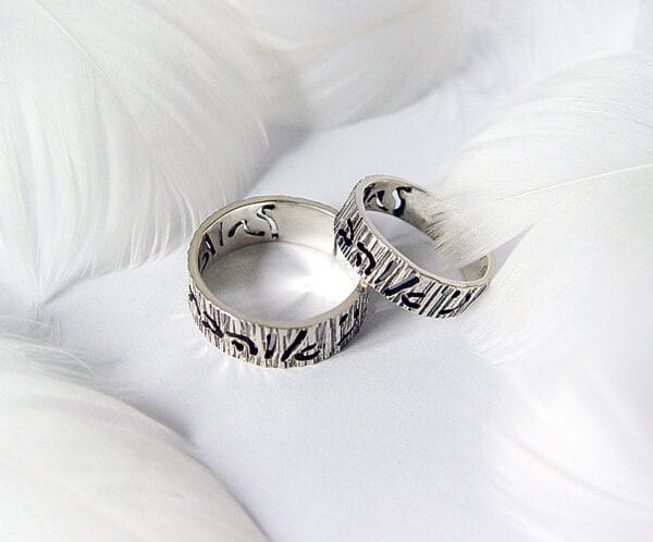 Covenant The "Covenant" silver wedding ring features the words "I love You" in Hebrew, one of the oldest scripts in the world, with an engraved tree pattern.