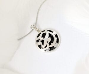 The silver necklace features a flying bird design called ‘Dance of the Holy Spirit’, a symbol of freedom and agility, perfect for any occasion.