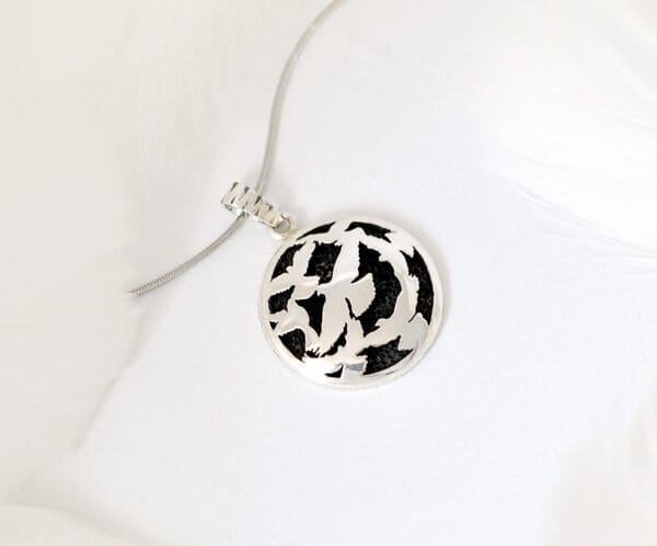 The dance of the Holy Spirit The silver necklace features a flying bird design called ‘Dance of the Holy Spirit’, a symbol of freedom and agility, perfect for any occasion.