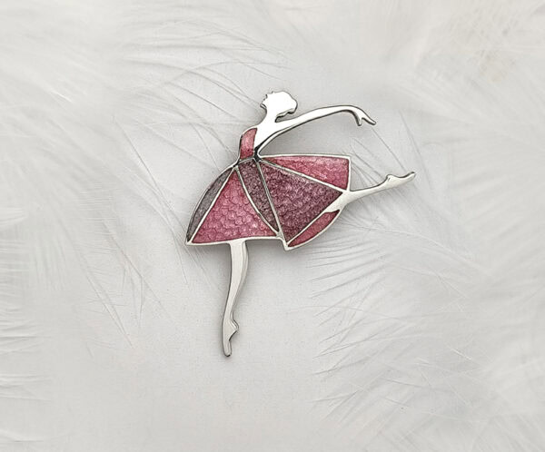 Dancing Moments Close-up of the "Dancing Moments" Champlevé Enamel 925 silver ballerina brooch against a white feather background. Features a geometric pink-lavender translucent enamel skirt with visible chiseled texture.