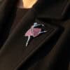 Dancing MomentsM The "Dancing Moments" Champlevé enamel ballerina brooch pinned to the lapel of a black wool coat, showing the styling and scale of the piece worn in natural sunlight.