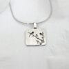 Magpie on the Plum The silver necklace of "Magpie on the Plum" shows a blooming plum branch and a flying magpie, symbolizing happiness and good luck, reflecting the Chinese flower and bird culture