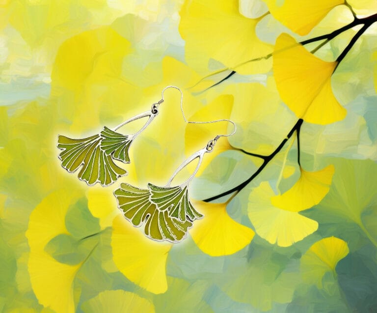 a pair of earrings with leaves on them