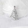 The silver Christmas tree brooch is topped with stars and decorated with snowflakes, showing the festive mood and magic of winter.