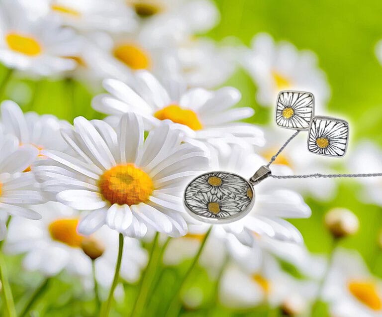 a necklace and earrings with flowers in the background