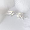 A pair of silver brooches, beautifully displaying a pair of swallows, symbolizing love and happiness, suitable for any occasion.