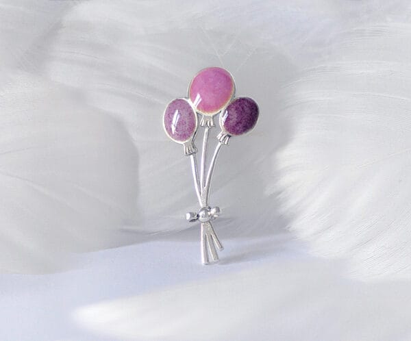 Silver brooch "Moments of Joy" with pink and purple enamel balloons, showing the atmosphere of joy and celebration