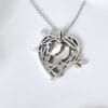 A sweet declaration silver brooch that can also be used as a pendant, showing the love nest of two birds, a design that conveys a warm and loving moment
