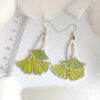 A pair of ginkgo leaf earrings in translucent enamel that showcase natural elegance and vivid green, perfect for everyday wear and special occasions.