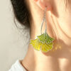 Model wearing Ginkgo Leaf Chartreuse 925 Silver Plique-à-jour Enamel Earrings, handcrafted with translucent vitreous enamel.