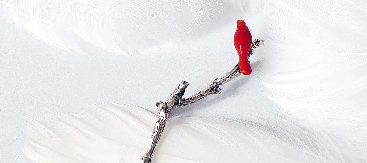 a red bird on a branch