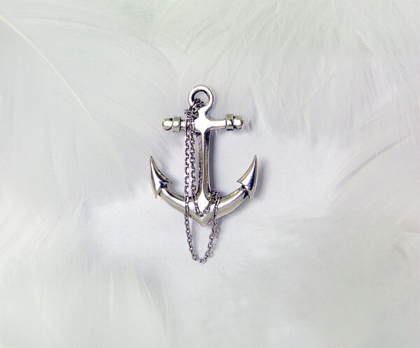 Cross anchor-shaped 925 sterling silver brooch, featuring a delicate design with a dangling silver chain. The polished finish exudes elegance and a stylish nautical theme accessory.