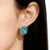 Close-up shot of a model wearing the "Still Waters Run Deep" blue and green Champlevé Enamel 925 silver earrings, highlighting the tranquil, flowing color design.