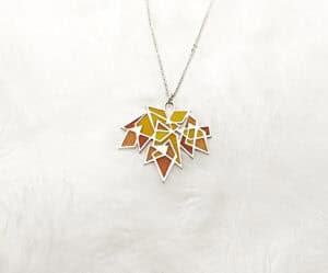 Handcrafted Maple Splendor Pendant in sterling silver with Plique-à-jour enamel, autumn maple leaf necklace capturing warm light.